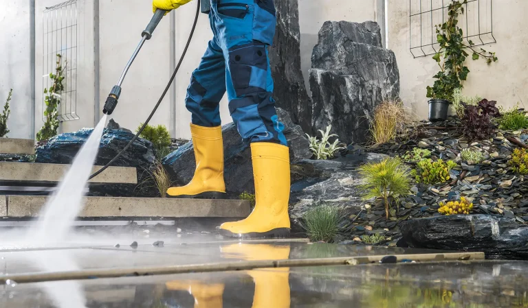 men-pressure-washing-his-garden-architectural-concrete-elements